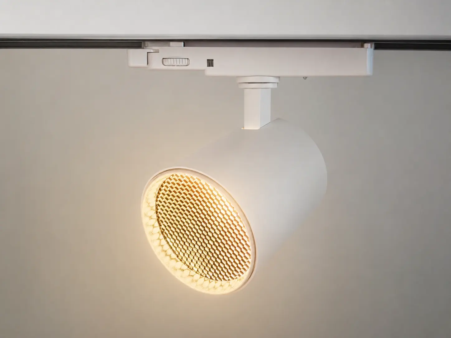 LED track light with honeycomb louver for advanced anti glare lighting control.